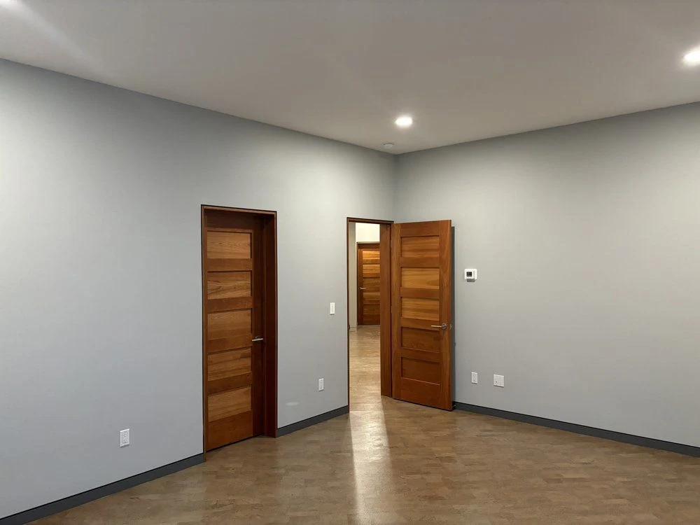 Painted walls and ceiling with wood doors retained.